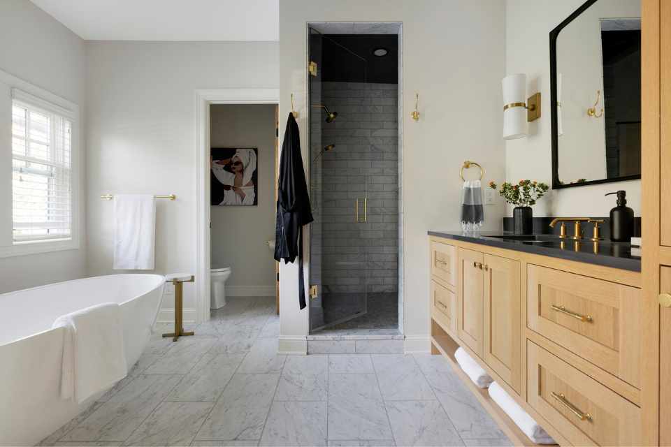 airy, natural white bathroom with wood vanity and marble floors